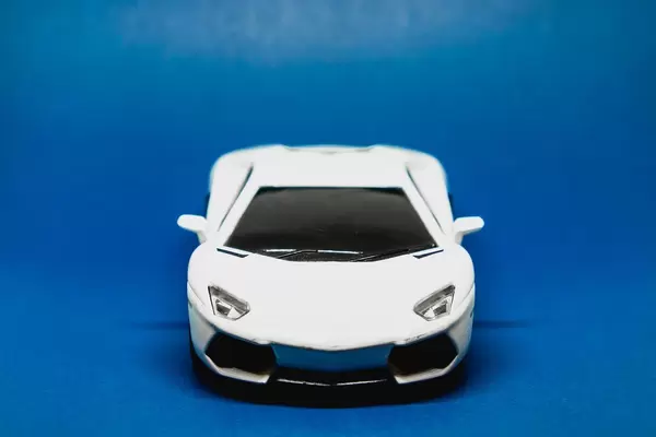 Toy car isolated on blue background (Flip 2019)