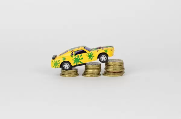Toy car on coin stack