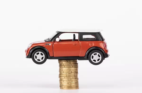 Toy car on stack of coins