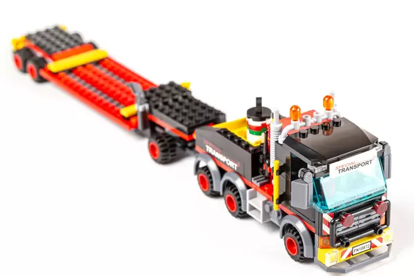 Toy colorful truck with trailer made of parts of the designer