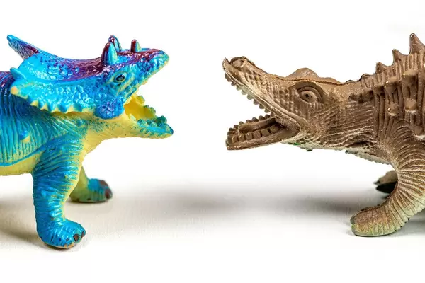 Toy dinosaurs on white background