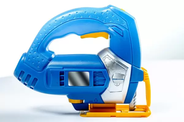 Toy electric jigsaw on white background (Flip 2019)