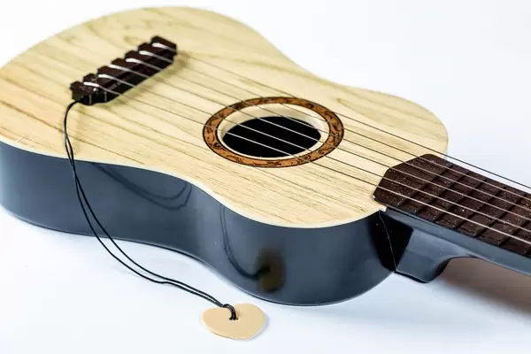 Toy guitar with strings