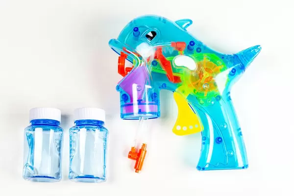 Toy gun for soap bubbles on a white background