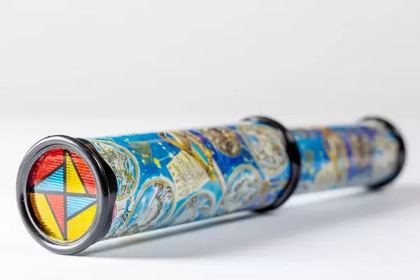 Toy kaleidoscope on white background