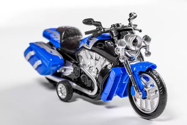 Toy motorcycle on white background (Flip 2019)