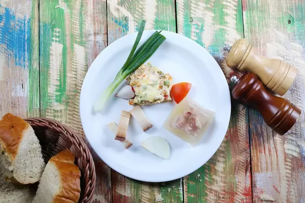 Traditional Balkan breakfast with pork jelly and bacon. Vintage background  (Flip 2019)
