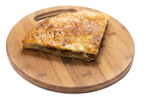 Traditional balkan burek pie with meat isolated over white background