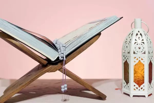 Traditional middle-eastern lantern and Islamic Holy book Koran. Islam, religion, Eid concepts (Flip 2020)