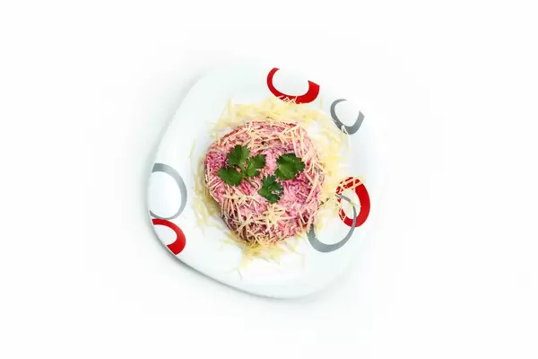 Traditional Russian salad Mimosa made of cheese, eggs, canned fish, onion, and mayonnaise