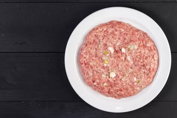 Traditional Serbian Pljeskavica with minced meat and onion