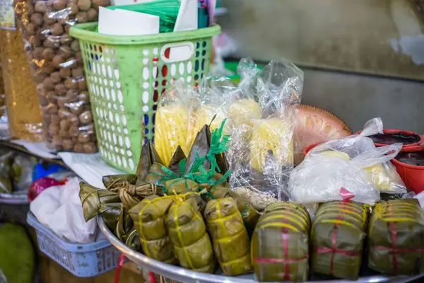 Traditionelle Reiskuchen mit Füllung Banh Tet auf einem Markt in Saigon