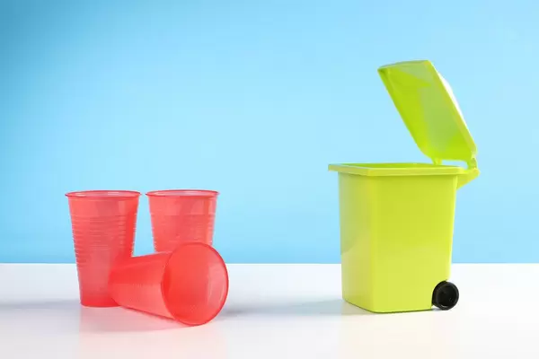Trash bin with a plastic cups