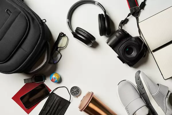 Travel accessories prepared for the trip on white background