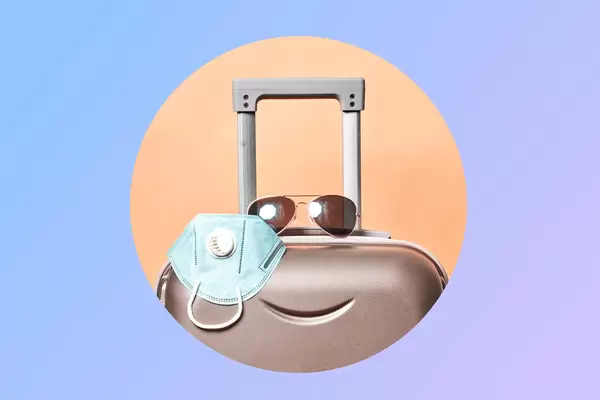 Travel bag, n95 face mask and sunglasses on creative circle layout