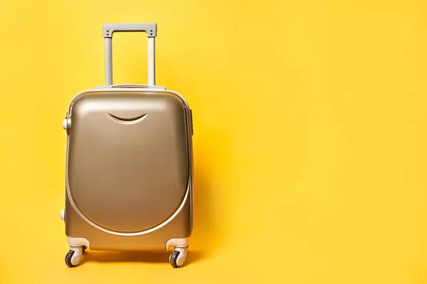 Travel suitcase on bright yellow background