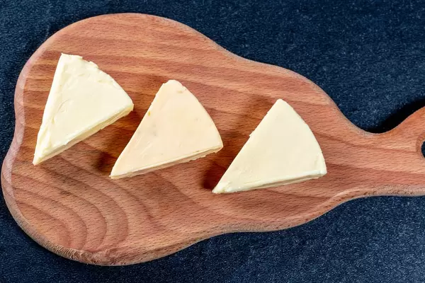 Triangles of processed cheese on the kitchen Board