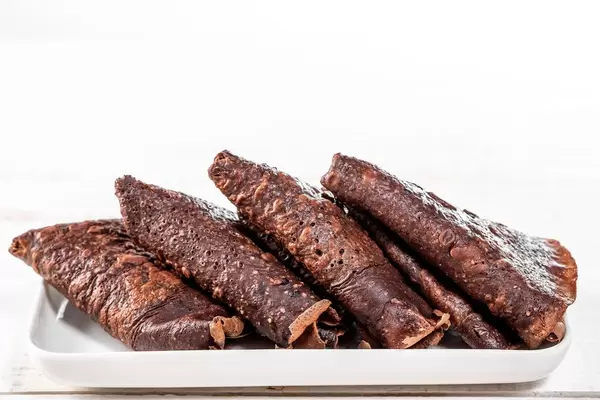 Triangles with chocolate brown pancakes on a white plate