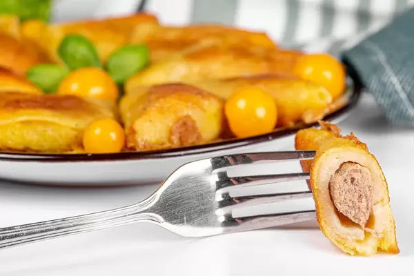 Triangular pancakes with meat filling, close-up