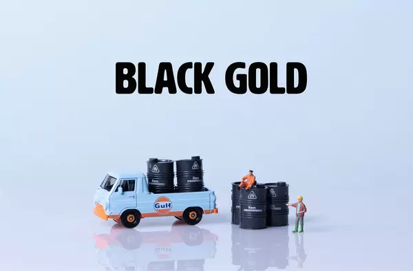 Truck and oil barrels with Black Gold text