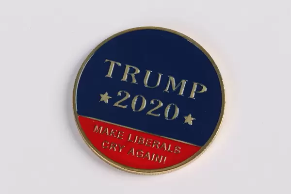 Trump 2020 text on a golden coin