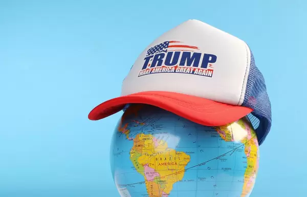 Trump classic trucker hat on a globe