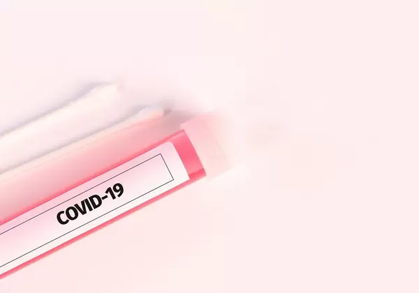 Tube with blood samples for Coronavirus test on white background