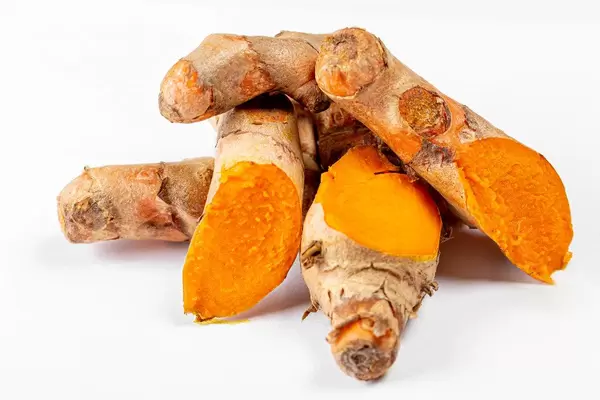 Turmeric roots on white background (Flip 2020)