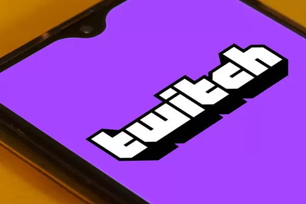 Twitch app launch screen with logo on the display of a black mobile smartphone