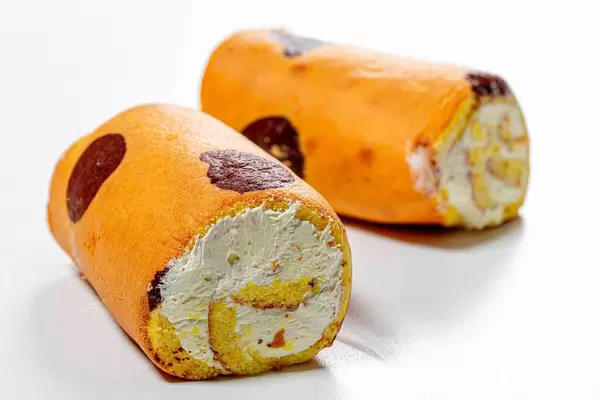 Two biscuit roll with cream on white background (Flip 2019)