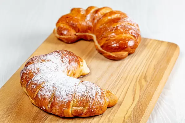 Two buns on a wooden kitchen Board