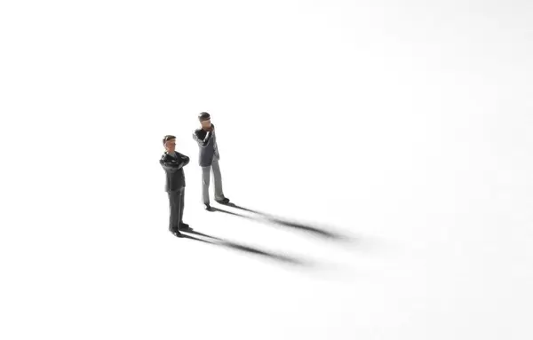 Two businessman standing on white background