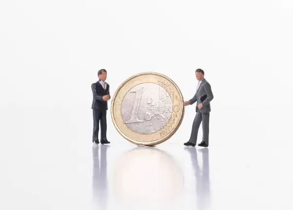 Two businessman with 1 Euro coin on white background