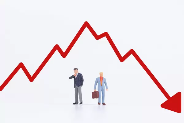 Two businessman with red down chart