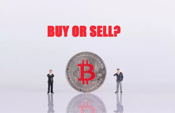Two businessman with silver Bitcoin coin and Buy or Sell text