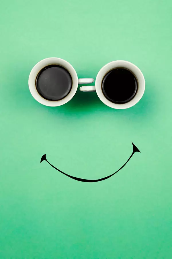 Two coffee cups with a smiling face