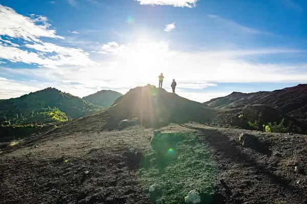Two friends standing in the sun on Pacaya Volcano, Guatemala