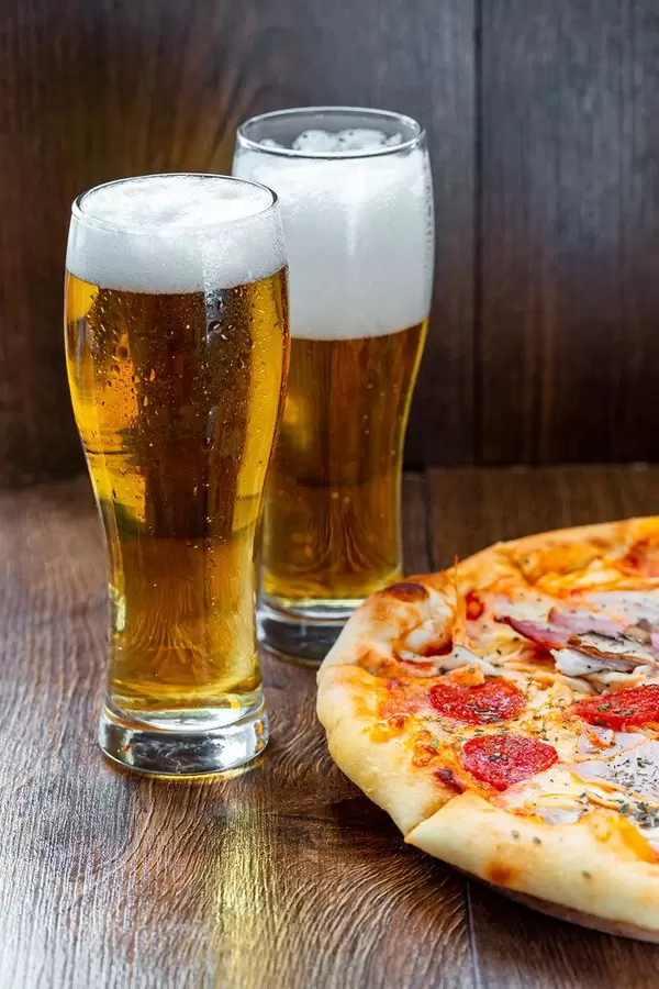 Two glasses of cold beer with pizza (Flip 2019) (Flip 2019)