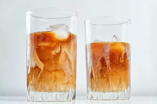 Two glasses of iced coffee with milk
