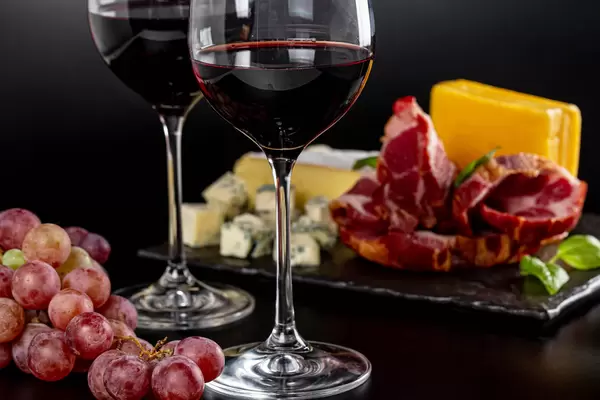 Two glasses of red semi-sweet wine with appetizers