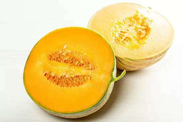 Two halves of ripe orange melon with seeds inside (Flip 2019)