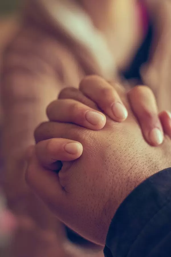 Two hands together, a man and woman holding hands. Husband and wife together. Support, loving, caring and understanding concepts (Flip 2020)