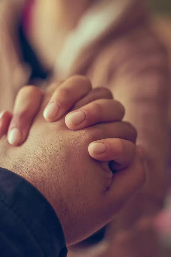 Two hands together, a man and woman holding hands. Husband and wife together. Support, loving, caring and understanding concepts