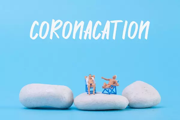 Two man relaxing in deck chairs with Coronacation text
