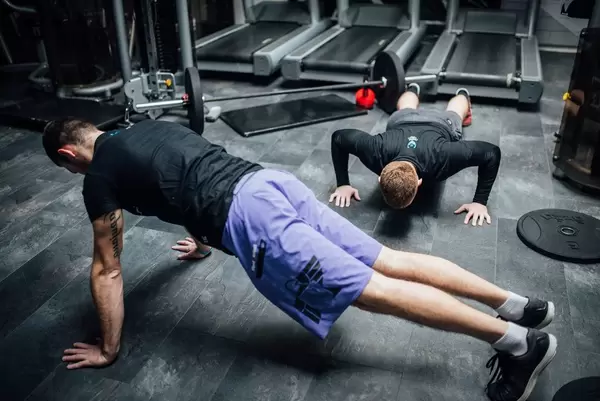 Two men exercising at the gym  Flip 2019