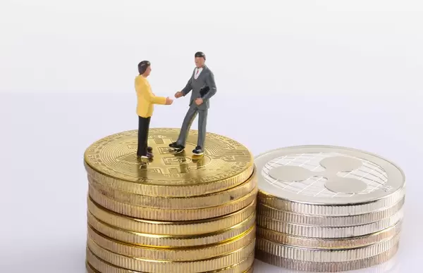 Two miniature people standing on coins