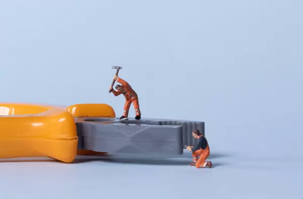 Two miniature workers with pliers