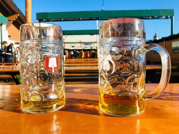 Two not completely drunk-up beer as a typical gesture at the Oktoberfest