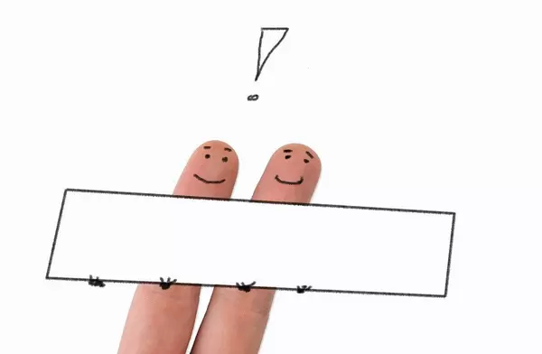 Two painted happy fingers with exclamation mark and empty board