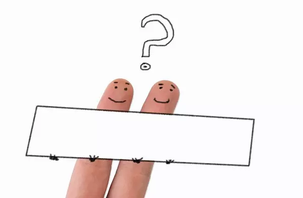 Two painted happy fingers with question mark and empty board